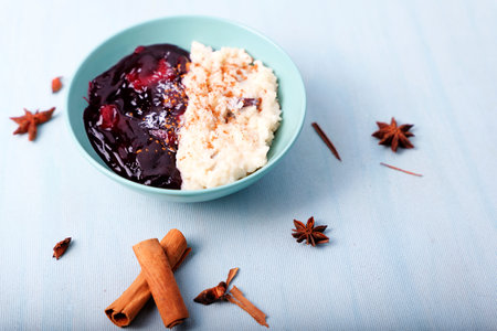Typical Peruvian dessert: rice pudding and purple mazamorra on a light blue background.の写真素材
