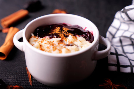 Typical Peruvian dessert: rice pudding and purple mazamorra on a dark background.の写真素材