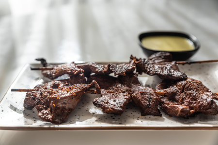 Rays of natural light illuminating a typical Peruvian dish called Anticuchos.