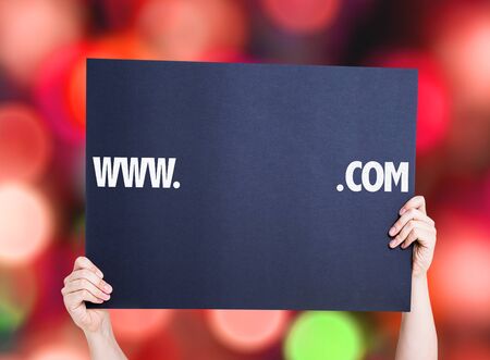 Hands holding www. .com with a copy space card with bokeh backgroundの写真素材