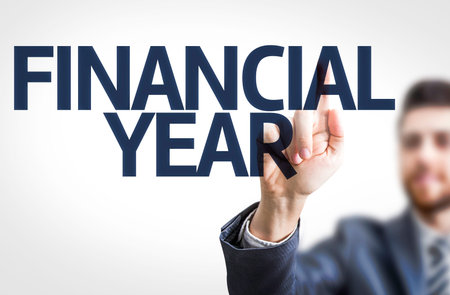 Business man pointing the text Financial Year