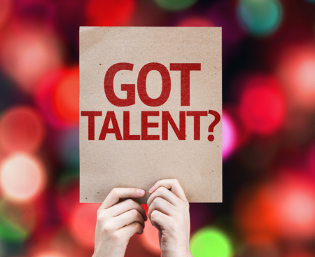 Hand holding cardboard with Got Talent on bokeh backgroundの写真素材