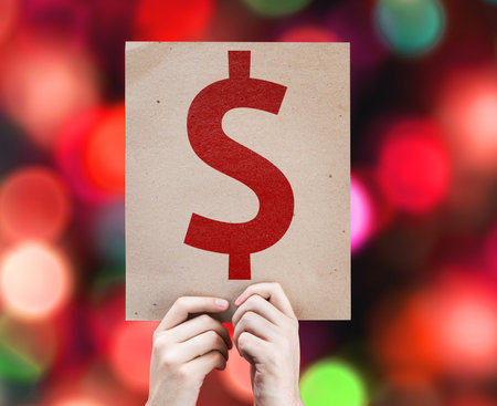 Hand holding cardboard with Money Symbol on bokeh background