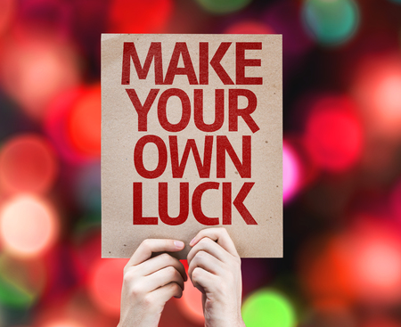 Cardboard with Make Your Own Luck on bokeh backgroundの写真素材