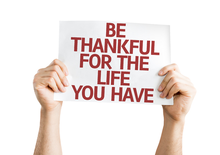 Hands holding Be Thankful for the Life You Have card isolated on whiteの写真素材