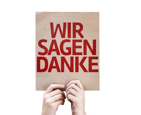 Hands holding We Say Thank You (In German) card isolated on white backgroundの写真素材
