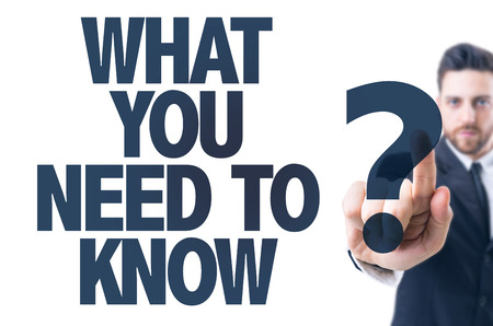 Business man pointing the text: What You Need to Know?の写真素材