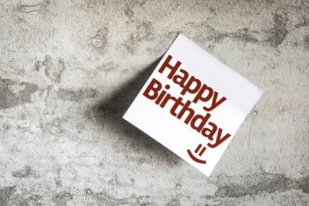 Happy Birthday written on paper note on texture backgroundの写真素材