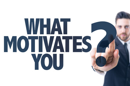 Business man pointing the text What Motivates You?の写真素材