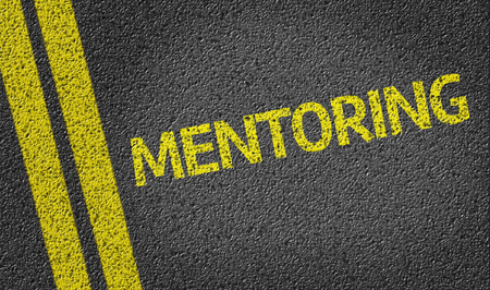Mentoring written on the roadの写真素材