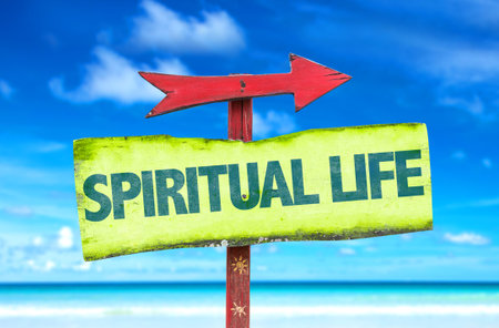 Signpost with text Spiritual life on beach background