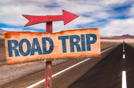Road Trip sign with arrow on a highway backgroundの写真素材