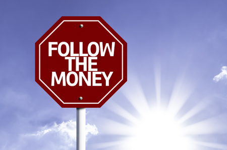 Follow The Money written on the road signの写真素材