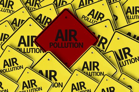 A red road sign amongst multiple road signs with text: Air Pollutionの写真素材
