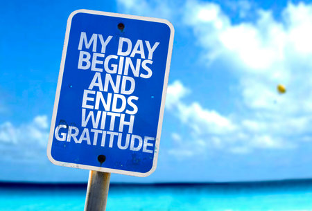 My Day Begins And Ends With Gratitude sign with sea background