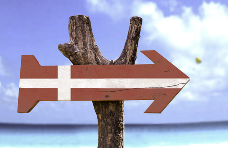 Denmark flag sign with arrow on beach backgroundの写真素材