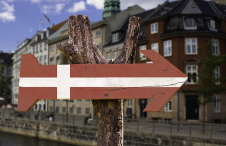 Denmark flag sign with arrow on Copenhagen view backgroundの写真素材