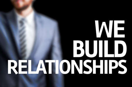 The word We Build Relationships with businessman backgroundの写真素材