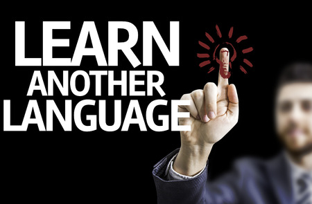 Business man pointing the text: Learn Another Languageの写真素材