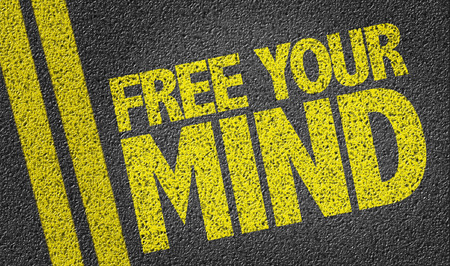 Text on tar road: Free your mindの写真素材
