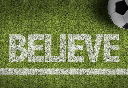 Text on soccer field: Believeの写真素材