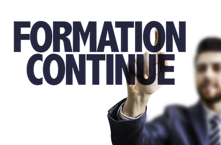 Business man pointing to transparent board with text: Formation continue (continuing education in French)の写真素材