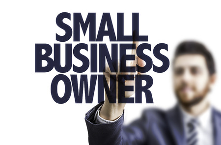 Business man pointing to transparent board with text: Small business ownerの写真素材