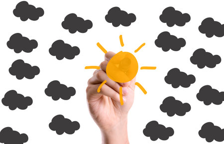 Sun with black clouds drawn with a marker penの写真素材