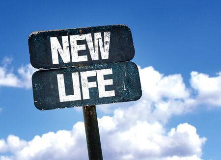 New life written on the road sign with clouds and sky backgroundの写真素材