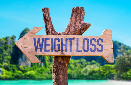 Weight loss sign with arrow on beach backgroundの写真素材