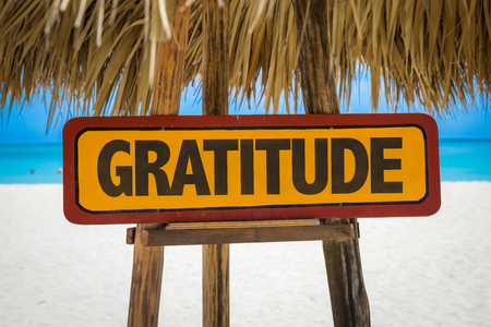 Wooden sign board in beach with text: Gratitudeの写真素材