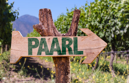 Wooden sign board in park with text: Paarl