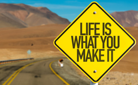 Life Is What You Make It sign on desert roadの写真素材
