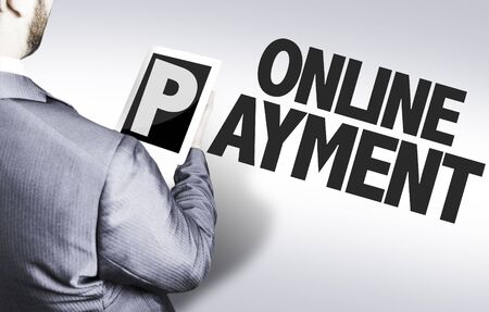 Executive holding a tablet pc with text: Online Paymentの写真素材