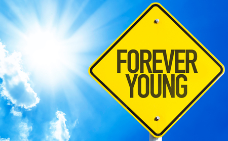 Forever Young road sign with sunny backgroundの写真素材