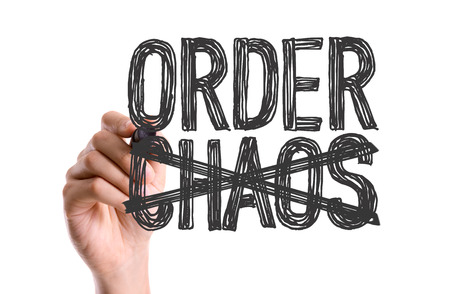 Hand with marker writing the word Order Chaosの写真素材