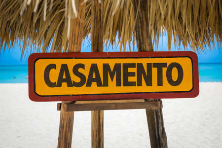Wedding in Portuguese sign with beach backgroundの写真素材