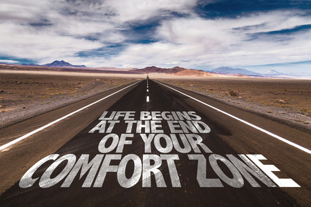 Life Begins at the End of your Comfort Zone written on desert roadの写真素材