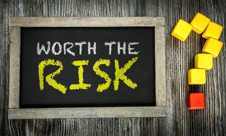 Worth the Risk written on chalkboardの写真素材