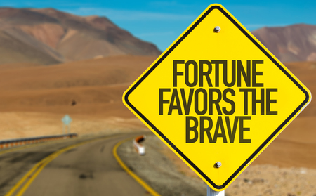 Fortune Favors the Brave sign on desert roadの写真素材