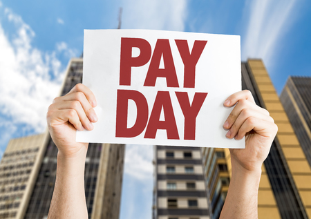 Download a compFind similar files Pay Day placard with cityscape backgroundの写真素材