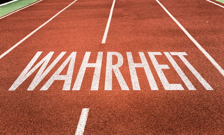 Wahrheit (truth in German) written on running track backgroundの写真素材