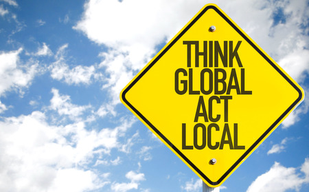Think global act local sign with clouds and sky background Think global act local sign with clouds and sky background