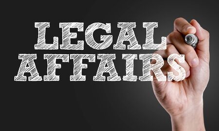 Hand holding a marker with Legal Affairsの写真素材