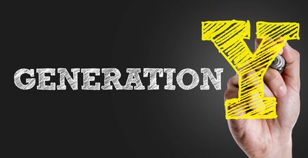 Hand holding a marker with Generation Yの写真素材