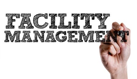 Hand holding a marker with facility management conceptの写真素材