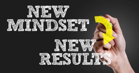 Hand holding a marker with New mindset new results conceptの写真素材