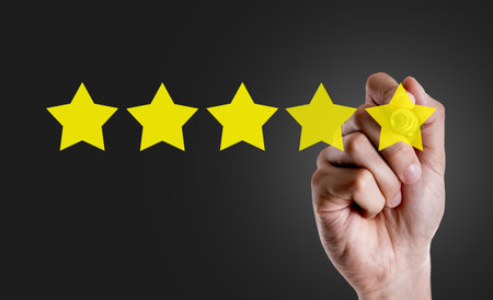 Hand holding a marker with 5 Stars concept