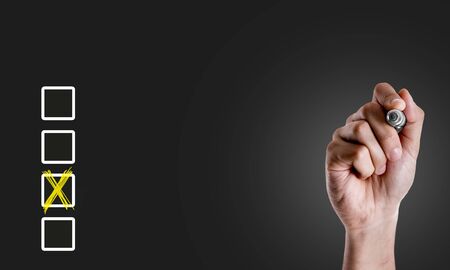 Hand holding a marker with survey conceptの写真素材