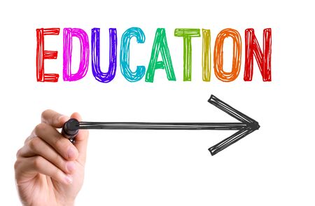 Hand drawing an arrow below educationの写真素材